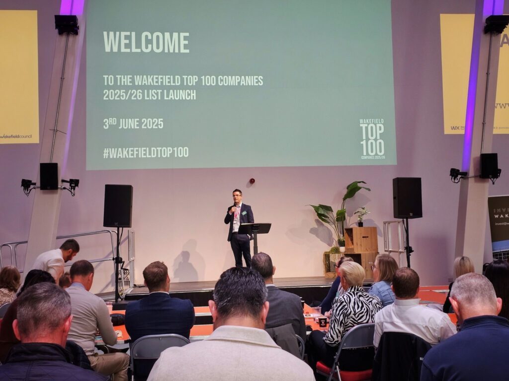 Man standing on stage at awards event