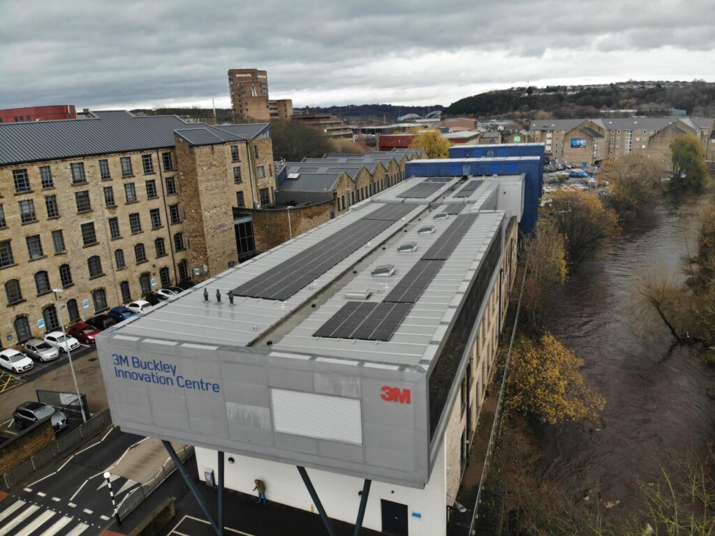 Birdseye view of an innovation centre with solar panels on the rooftop.