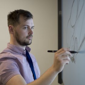 man sketching car